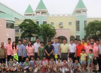 The Chinese badminton team take photos of themselves with the children.
