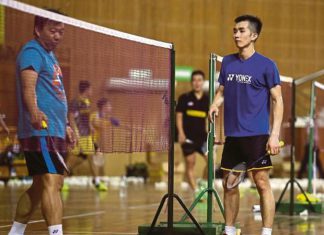 Coach Tey Seu Bock gives advice to Chong Wei Feng during the training session.