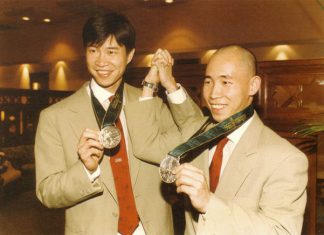 Cheah Soon Kit (left) and Yap Kim Hock pose with their 1996 Olympic silver medals.