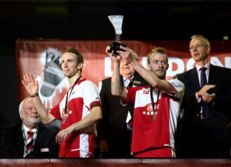 Mathian Boe (L) and Carsten Mogensen (R) of Denmark lift the 2013 London Badminton Grand Prix trophy.