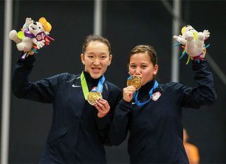 Eva Lee and Paula Lynn Obanana of USA pose for pictures after winning the 2015 Pan Am Games. (photo: GettyImages)
