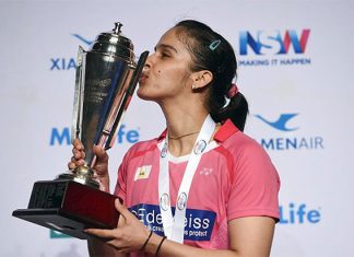 Saina Nehwal kisses the trophy after winning the Australian Open women's singles final. (photo: AFP)