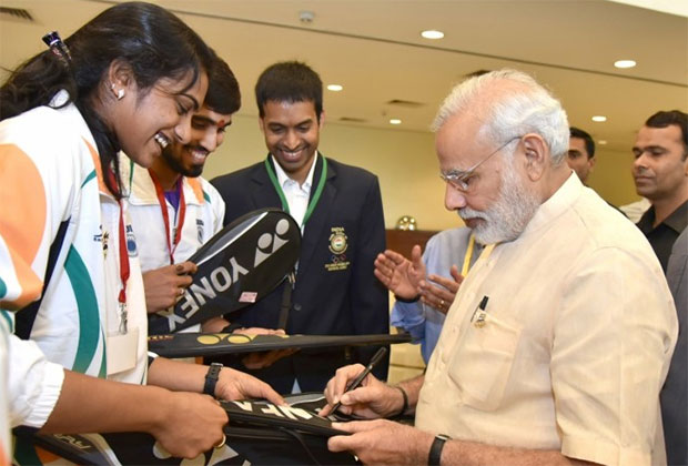 P.V Sindhu and Kidambi Srikanth get autograph from Prime Minister Narendra Modi. (photo: business-standard) P.V Sindhu and Kidambi Srikanth get autograph from Prime Minister Narendra Modi. (photo: business-standard)