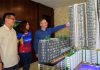 Goh Liu Ying/Chan Peng Soon look at a housing model by the Jaya Mapan Group. (photo: Nanyang)