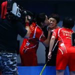 Chen Qingchen/Jia Yifan kiss their coach after winning the 2016 BWF World Superseries title. (photo: AFP)