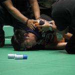 Pannawit Thongnuam receives medical attention after collapsing on court.