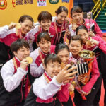 Japan’s gold medal-winning BATC women’s team take a selfie during the medal ceremony. (photo: AP)