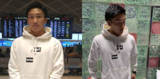 Kento Momota answers questions from reporters at Narita International Airport.