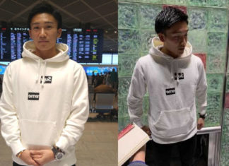Kento Momota answers questions from reporters at Narita International Airport.