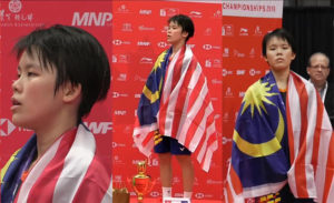Goh Jin Wei stands on the podium for the Malaysia national anthem after winning the world junior gold. (photo: BadmintonCanada)