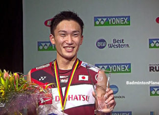 Kento Momota holds the German Open trophy after beating teammate Kenta Nishimoto in the final.