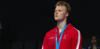 Anders Antonsen stands on the podium for the Denmark National Anthem following his victory in the men's singles final. (photo: European Games, Minsk)