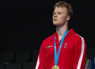 Anders Antonsen stands on the podium for the Denmark National Anthem following his victory in the men's singles final. (photo: European Games, Minsk)