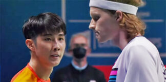 Loh Kean Yew (L) greets Anders Antonsen after the 2021 BWF World Championships semi-final match.
