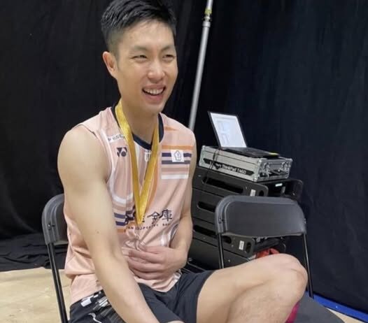 Chou Tien Chen sits with his gold medal after winning the 2025 Arctic Open, his sock stained with blood from a blistered foot. (Photo: Social Media)
