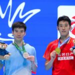 Hu Zhe An and Kantaphon Wangcharoen pose together during the awards ceremony at the 2026 Macau Open badminton tournament. (Photo: Xinhua)