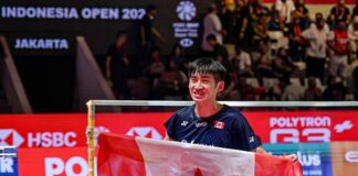 Victor Lai celebrates with a Canadian flag after defeating Jonatan Christie to win the Indonesia Open badminton men’s singles title in Jakarta. (Photo: AFP)