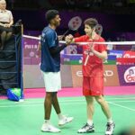 Shi Yuqi shakes hands with India’s Ayush Shetty after his first-round exit at the 2026 BWF World Championships in New Delhi. (Photo: AFP)
