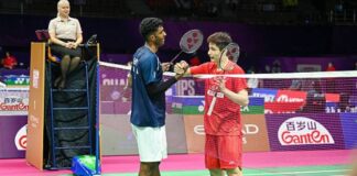 Shi Yuqi shakes hands with India’s Ayush Shetty after his first-round exit at the 2026 BWF World Championships in New Delhi. (Photo: AFP)