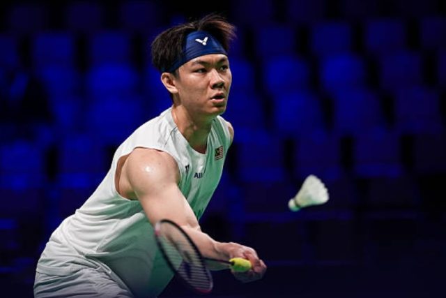 Malaysia's Lee Zii Jia battles Japan's Kodai Naraoka in the second round of the 2026 HYLO Open in Saarbrücken, Germany. Despite struggling with illness, Lee pushed the world No. 9 to three games before losing 21-11, 13-21, 14-21. (Photo: AFP)